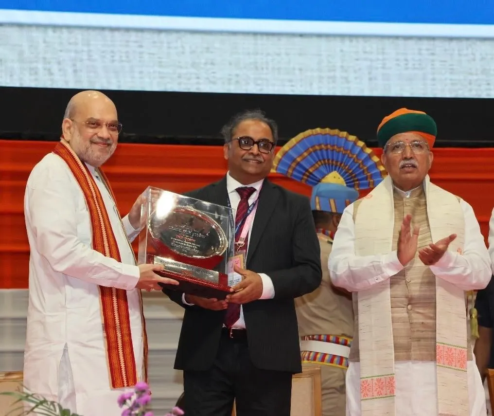 Shri Amit Shah, Union Minister of Home and Minister of Cooperation presenting the R Rajbhasha Kirti Puraskar Award for 2024-25 to Shri Ajay Kumar Srivastava, Managing Director & CEO of Indian Overseas Bank