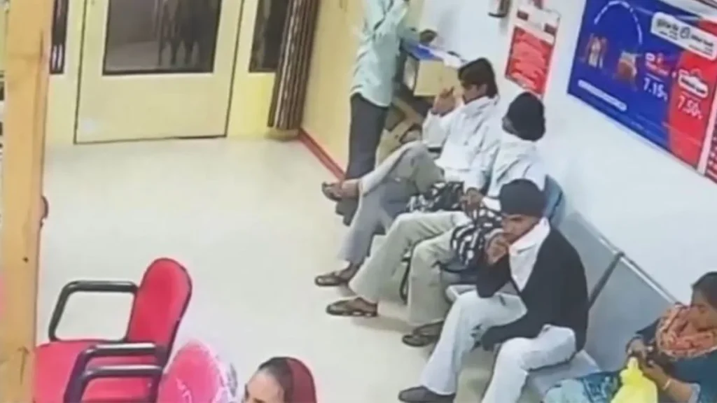 Robber sitting with face covered in Union Bank in Amritsar